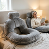 Reading pillow with arms in use on a bed, Gray