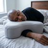 Side sleeper pillow with arm hole in use, Gray