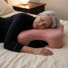 Side sleeper pillow with arm hole in use, Pink