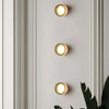 Dimple wall sconce mounted beside a mirror