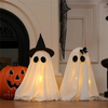Ghost figure with pointed witch hat, white draped fabric
