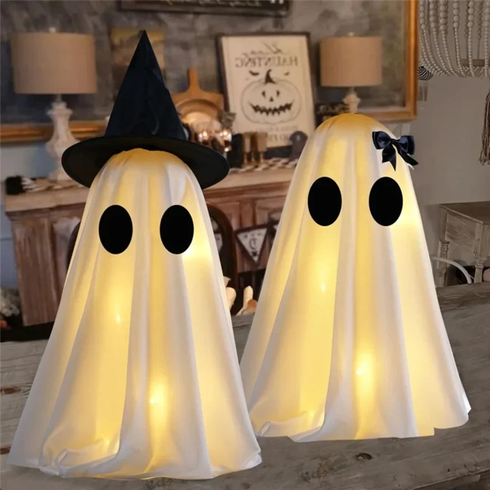 Pair of white ghost decorations on a Halloween console table