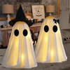 Pair of white ghost decorations on a Halloween console table