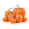 Seven orange foam pumpkins in graduated sizes on a white background