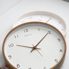 Solid wood wall clock detail showing grain and numerals