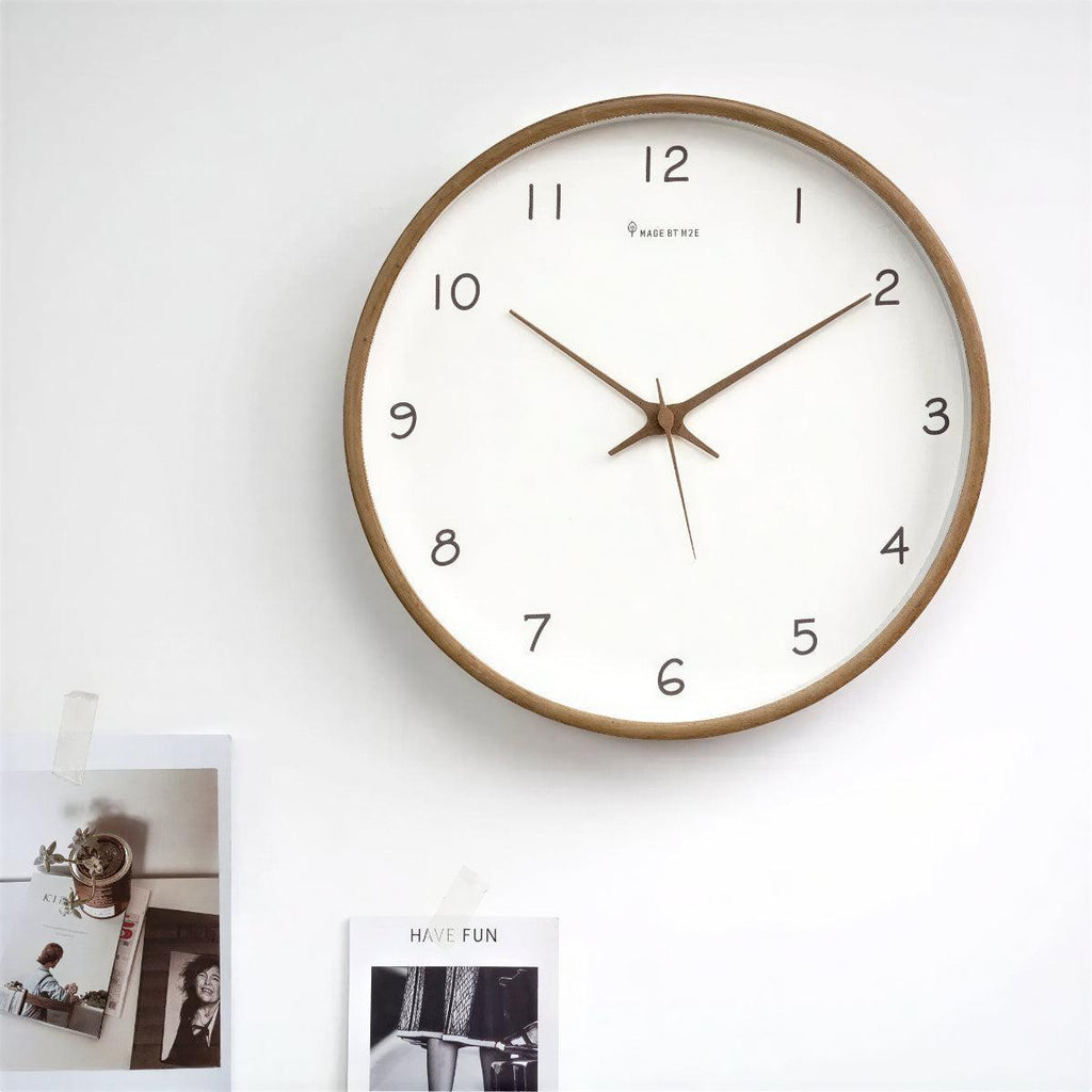 Minimalist wooden clock hanging in a study