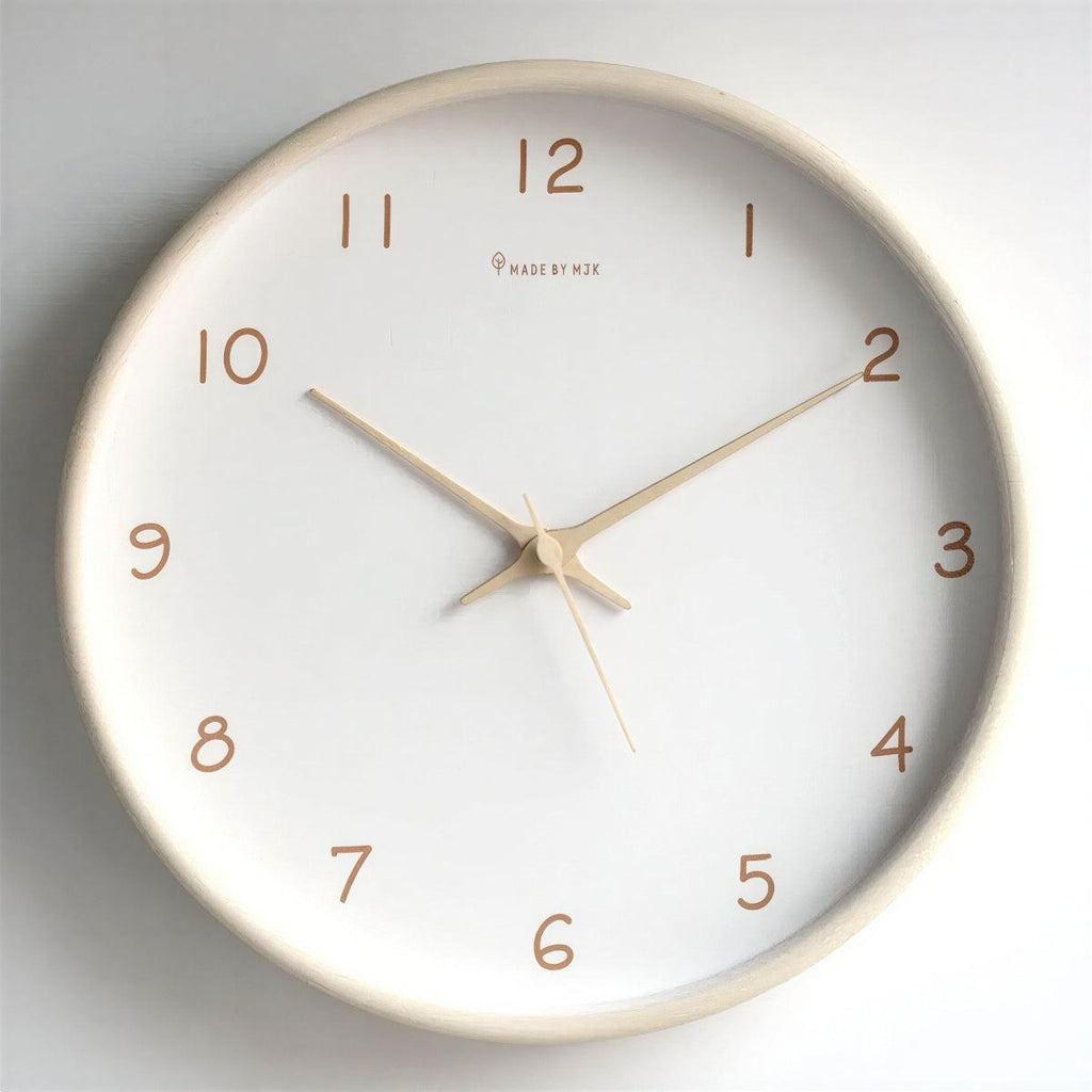 Cream solid wood silent wall clock on a pale wall