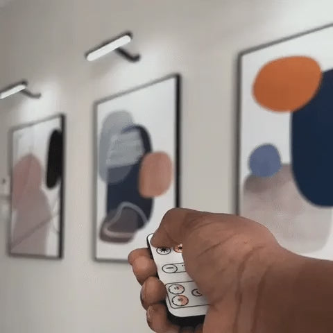 Cordless picture light turned on with the remote over wall art