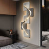 Geometric wall art with LED backlight, backlit wave wall light beside a bed